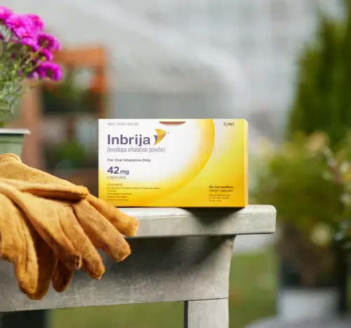 The Inbrija packaging on a gardening table