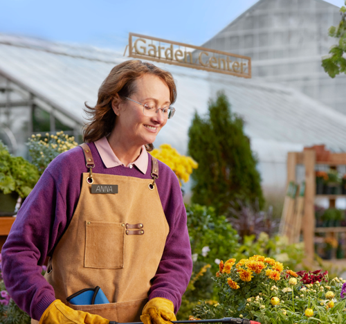 Woman smiling while working in a garden 
