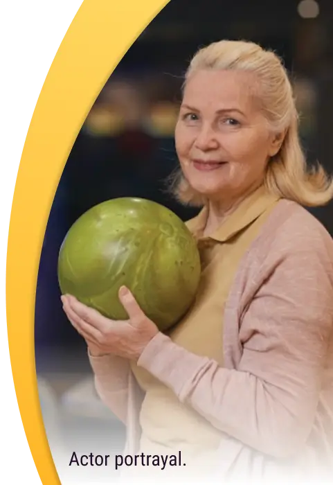 Portrait shot of Andrea holding up a bowling ball