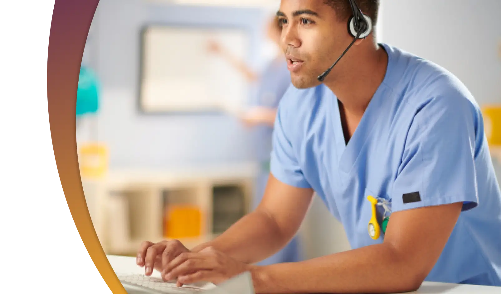 A male nurse working at his desk with a headset on